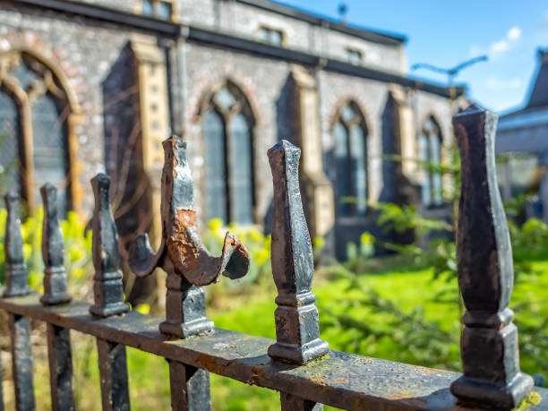 istock Close up and selective focus on black metal railings bordering a ancient church yard 1210271928