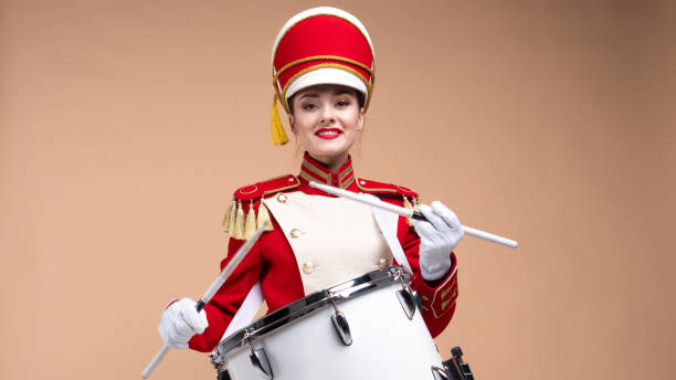 istock drummer in a red uniform drums on a drum, show program and celebration. 1210276012