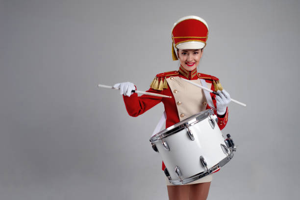 istock drummer in a red uniform drums on a drum, show program and celebration. 1210276289
