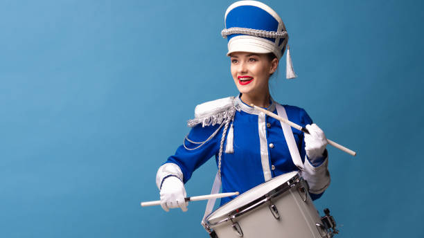 istock drummer in a blue uniform drums on a drum, show program and celebration. 1210278189