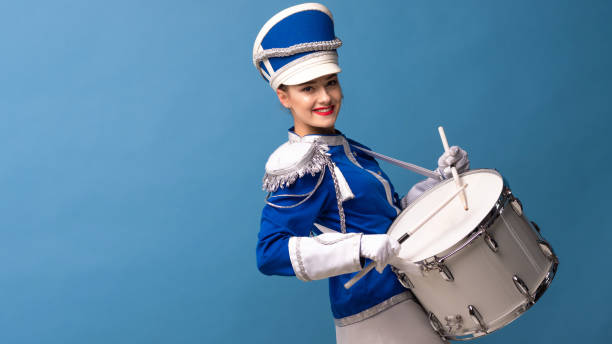 istock drummer in a blue uniform drums on a drum, show program and celebration. 1210278259