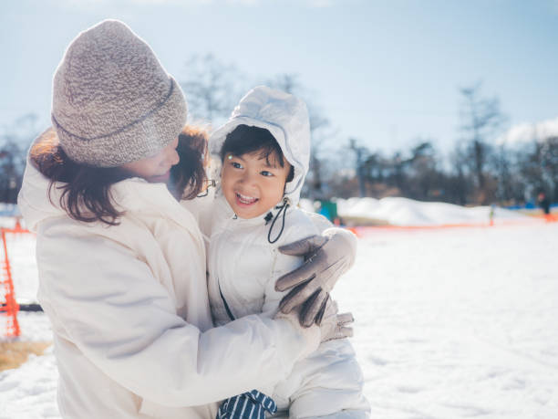 istock Family Building A Snowman 1210281459