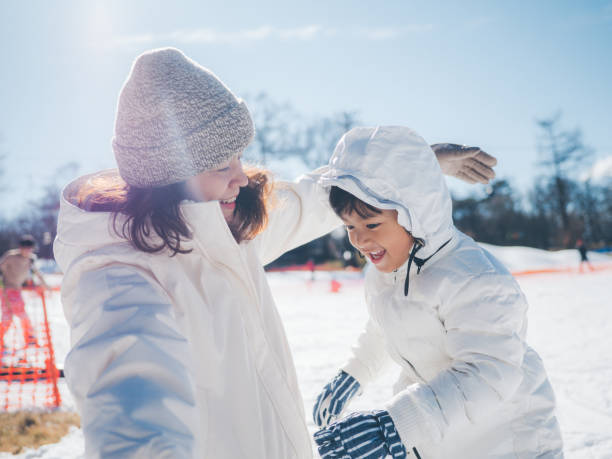 istock Mother and son having fun in snow in Japan. 1210281479