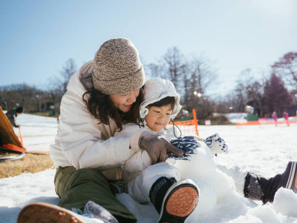 istock Family Building A Snowman 1210281527