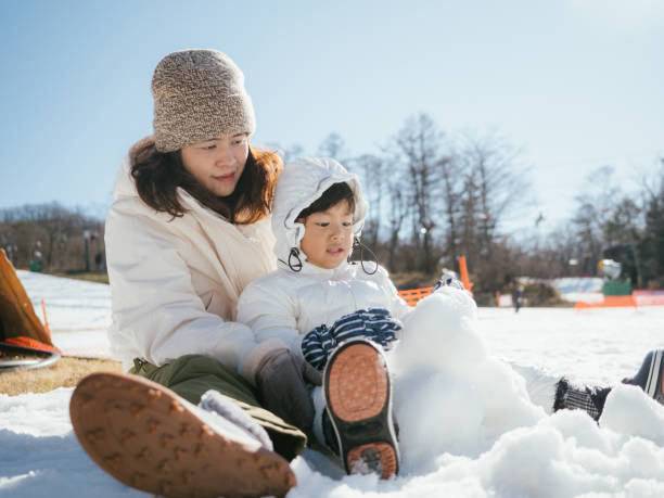 istock Mother and son having fun in snow in Japan. 1210281566