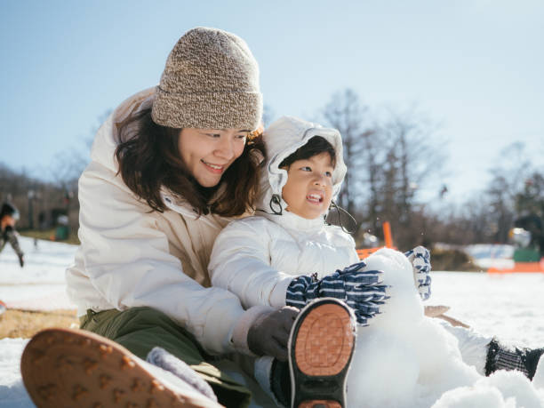 istock Family Building A Snowman 1210281570