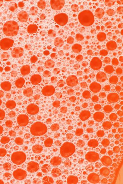 istock Foam close-up bubbles on a bright orange background. Orange soap foam macro background. Soap bubbles orange color with a white gradient. Bath foam. Cleanliness and order. 1210283054