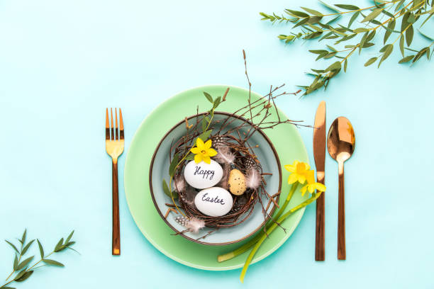istock Easter table setting concept, top down view of table arrangement with greeting decorative composition 1210283990