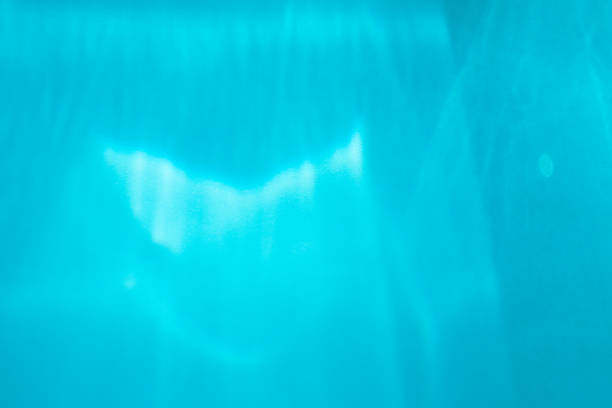 istock Defocused underwater blur and bokeh abstract summer background with selective focus, close-up. Blue shiny backdrop 1210284740