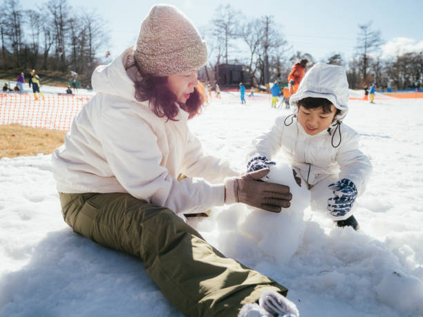istock Family Building A Snowman 1210287713