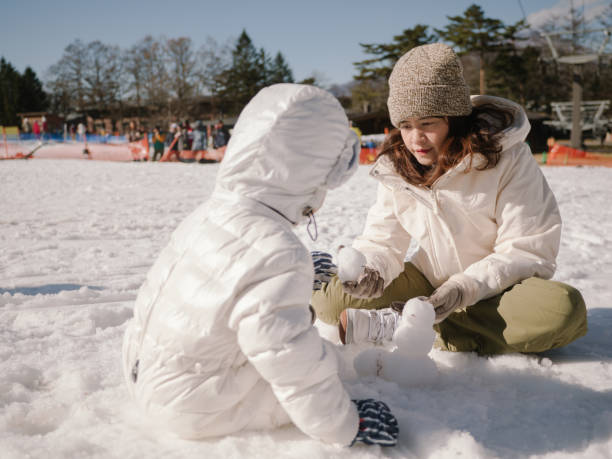 istock Family Building A Snowman 1210287722