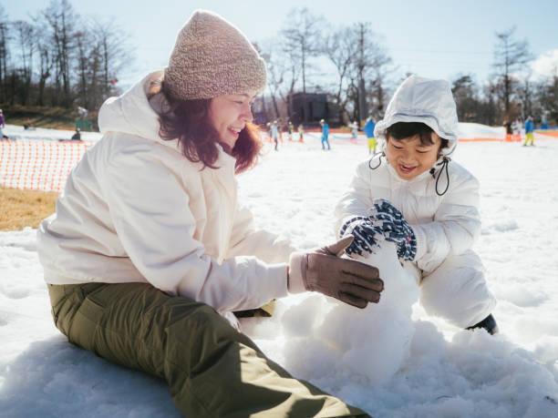 istock Family Building A Snowman 1210287751