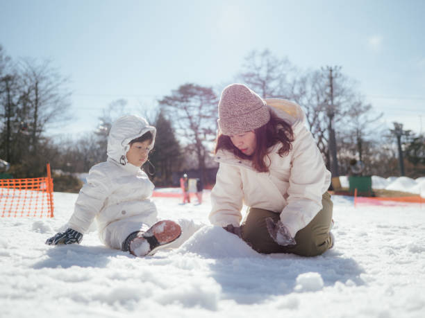 istock Mother and son having fun in snow in Japan. 1210287775