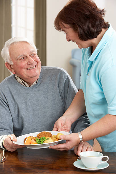 istock Senior Man Being Served Meal By Carer 121028966