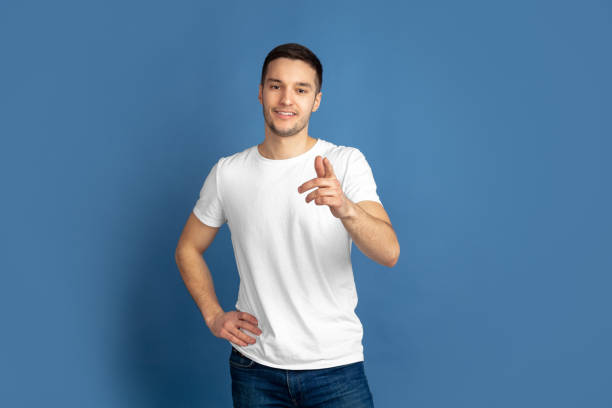 istock Caucasian young man's portrait on blue studio background 1210289874