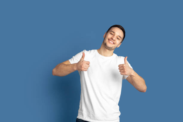 istock Caucasian young man's portrait on blue studio background 1210289877