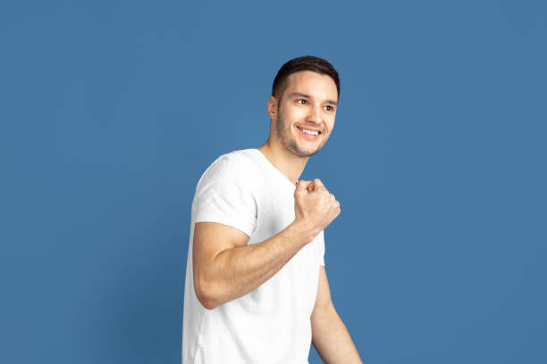 istock Caucasian young man's portrait on blue studio background 1210289890