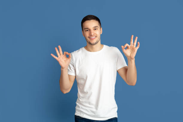 istock Caucasian young man's portrait on blue studio background 1210289892
