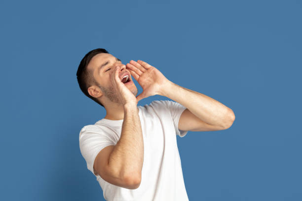 istock Caucasian young man's portrait on blue studio background 1210290055