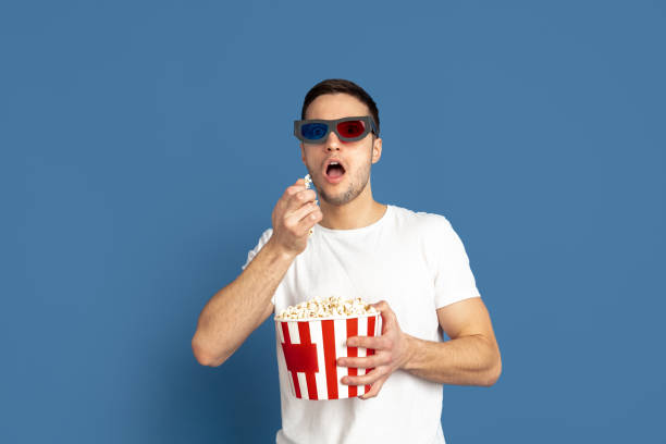 istock Caucasian young man's portrait on blue studio background 1210290080