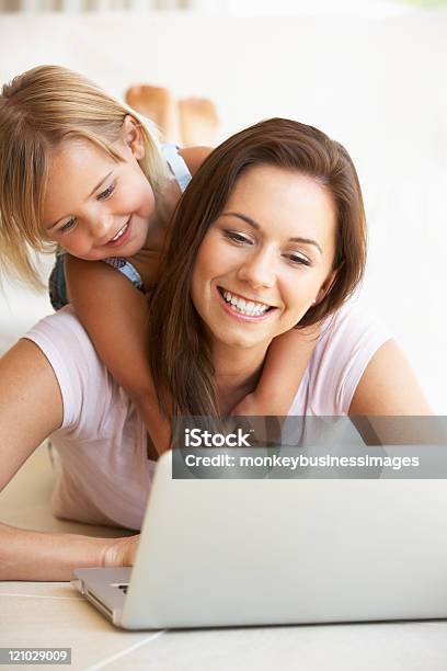 Young Mother And Daughter Using Laptop Computer Stock Photo - Download Image Now - Working At Home, Mother, Working Mother