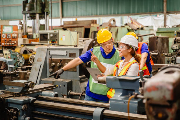 istock Mix race worker working together help each other to work in heavy industry machine wearing safty suit in factory production line.engineer with tablet coworking with team staff. 1210290690