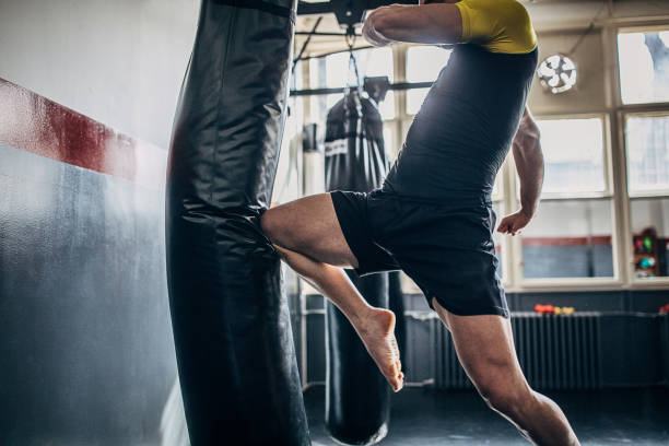 istock Low kick with knee in the punching bag 1210291970