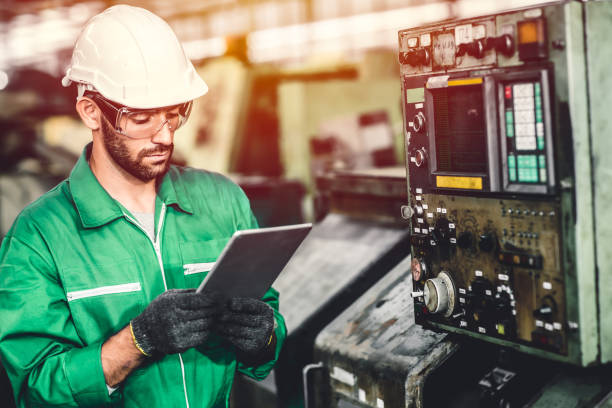 istock Green eco worker checking energy consumption engieer working in heavy industry factory with green colour safety suit. 1210292013