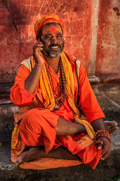 istock Sadhu - indian holyman using mobile phone 1210293657