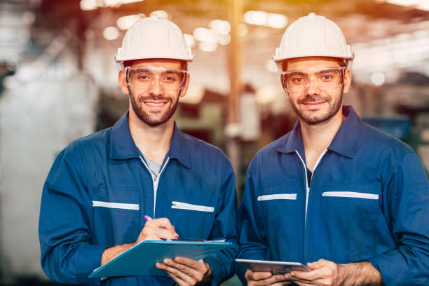 istock Portrait of happy engineer teamwork smiling looking at camera. 1210293674