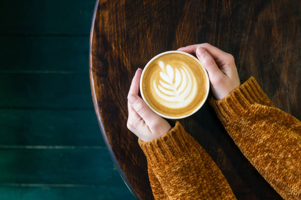 istock Cup of cappuccino with latteart in hands. 1210293871