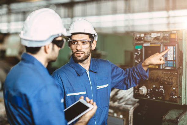 istock Engineer team talking together to discussion teach and learn give education technical about using machine in factory workplace. 1210294119