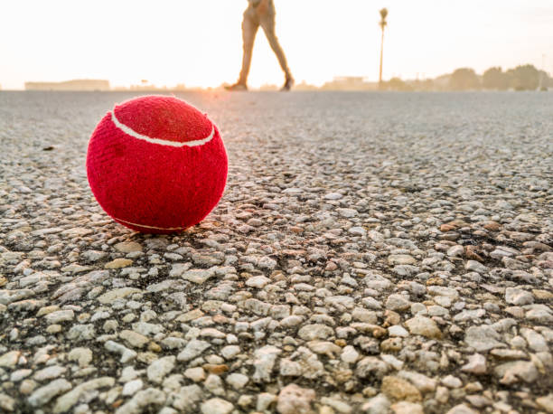 istock Red Cricket ball is on the ground with sunlight 1210294177