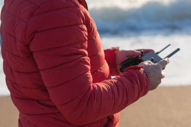 Man flying his drone at the beach closeup