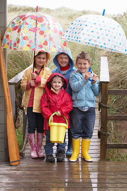 istock Children standing under umbrella 121029620