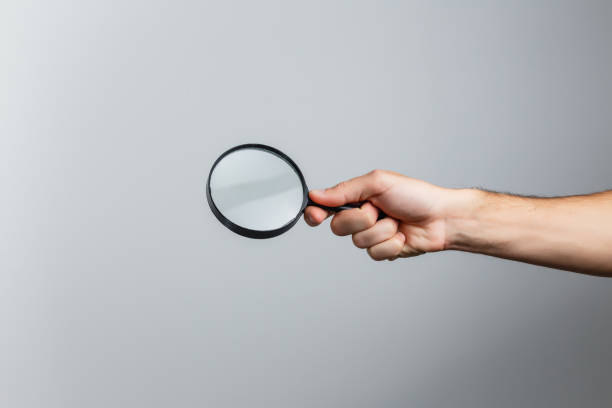 istock magnifying glass in woman hand 1210296907