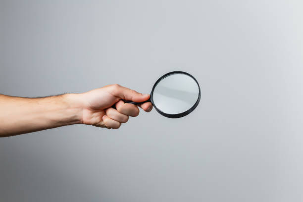 istock magnifying glass in woman hand 1210296937