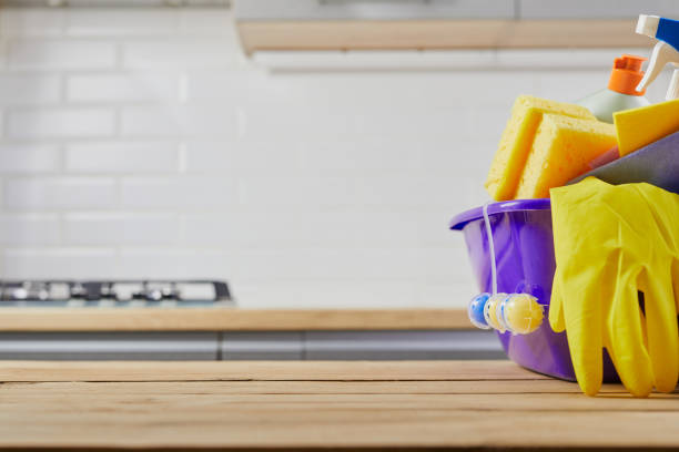 istock Cleaning supplies : sponge, bottle , glove, spray on table and gray kitchen background, close up 1210299752