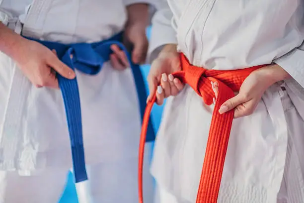 Photo of Teenagers tying karate belt