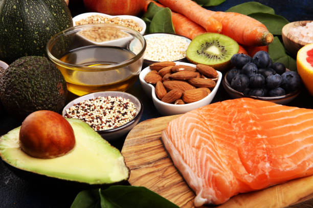 istock Healthy food clean eating selection: fish, fruit, vegetable, cereal, leaf vegetable on rustic background 1210302239