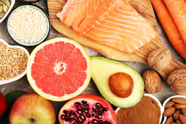 istock Healthy food clean eating selection: fish, fruit, vegetable, cereal, leaf vegetable on rustic background 1210302388