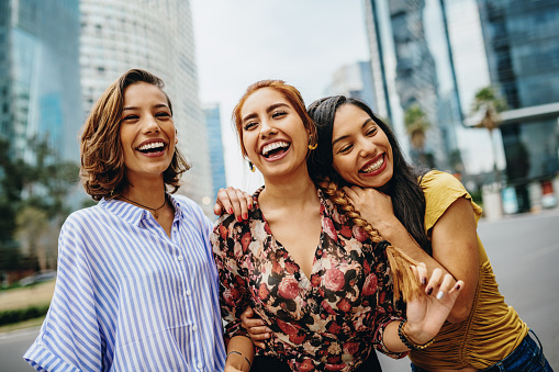 Hispanic young millennial women having fun together on city break in Mexico