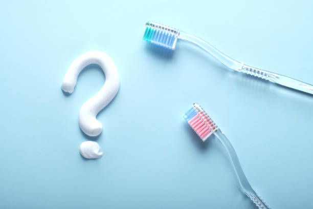 istock A question mark toothpaste and a pair f toothbrushes on blue. 1210302438
