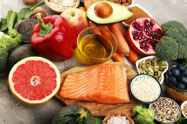 istock Healthy food clean eating selection: fish, fruit, vegetable, cereal, leaf vegetable on rustic background 1210303040