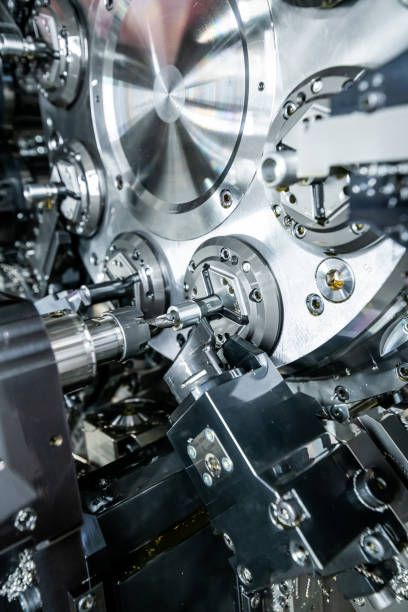 istock Mechanical industry machinery: inside of a modern multi-spindle CNC lathe machine 1210303110