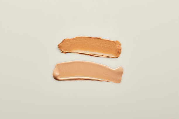 istock Top view of beige tone cream brushstrokes on grey background 1210303321