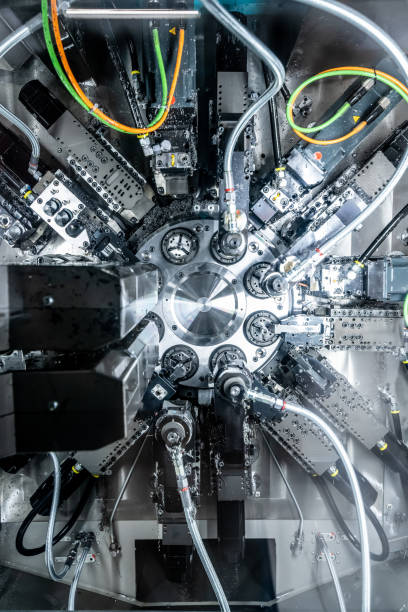 istock Mechanical industry machinery: inside of a modern multi-spindle CNC lathe machine 1210303532