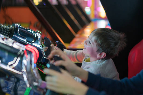 istock Happy brothers playing arcade game 1210303544