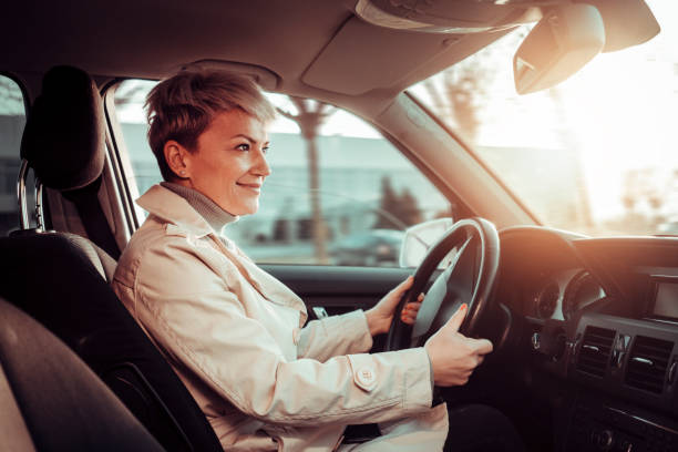 istock Smiling woman in a car 1210303751