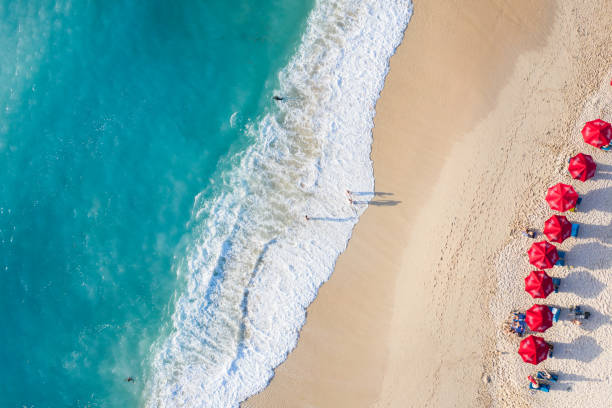 istock Beach umbrellas and blue ocean. Beach scene from above 1210303959